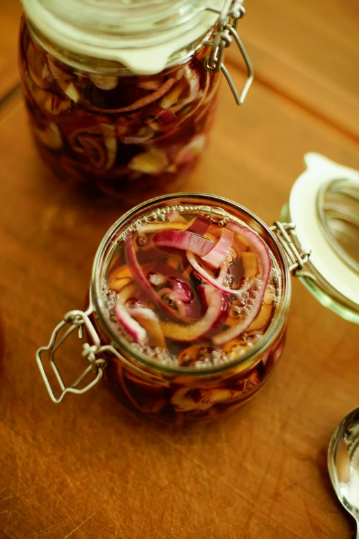 the jars have pickled vegetables inside of them