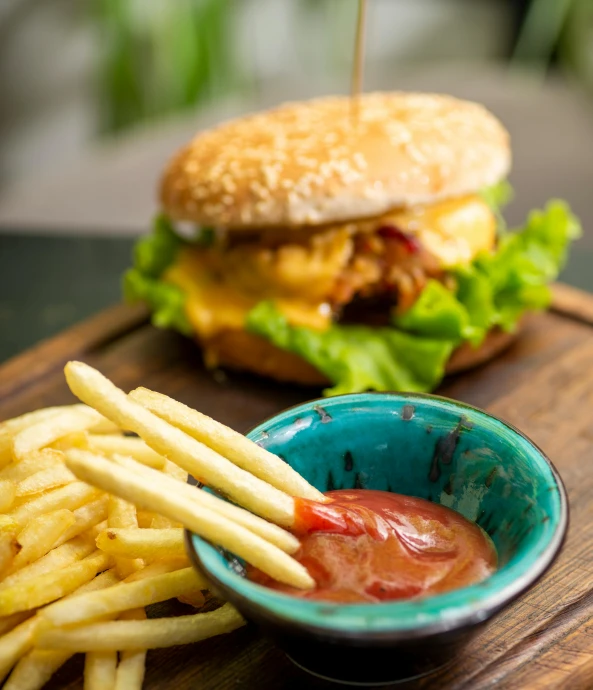 burger with french fries and ketchup on a table