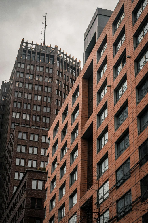 three very tall brick buildings next to each other