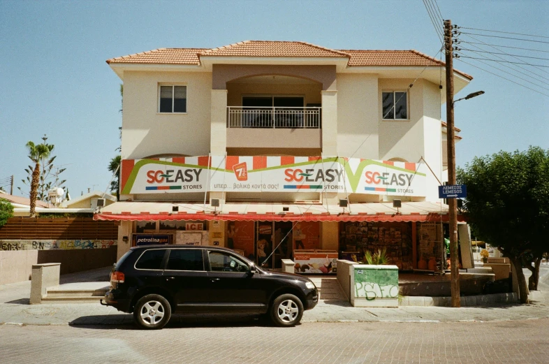 a car parked outside a restaurant on the side of the street