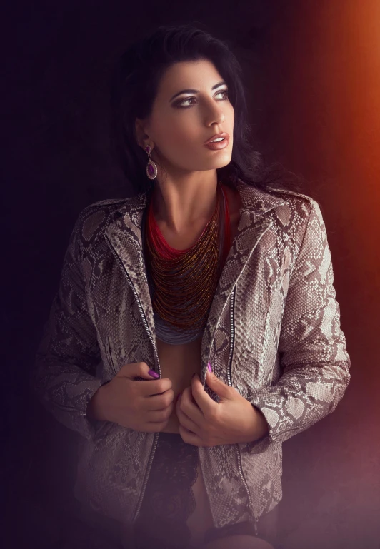 a woman wearing a metallic jacket in the dark