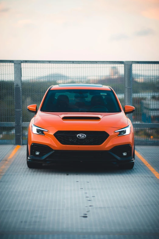 an orange car is parked in a parking lot