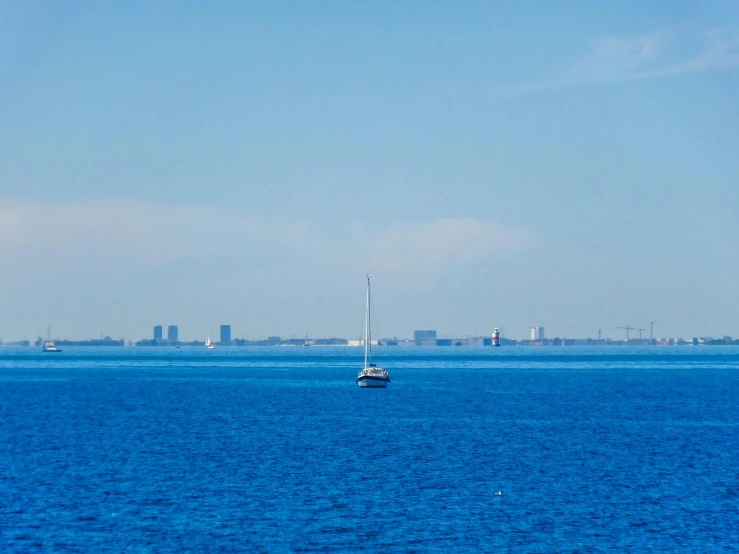 a boat traveling on the ocean during the day