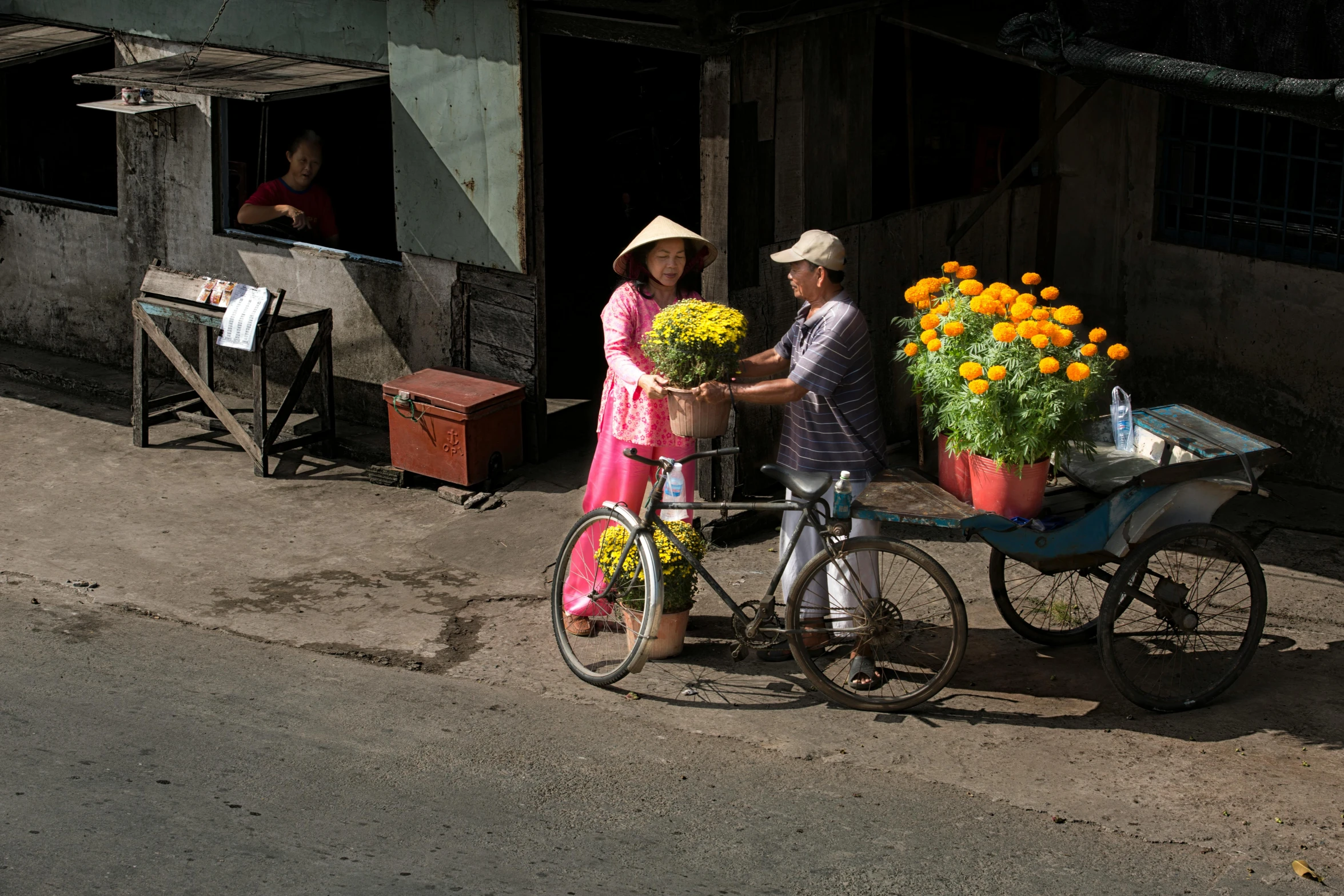 two people on a bike with flowers