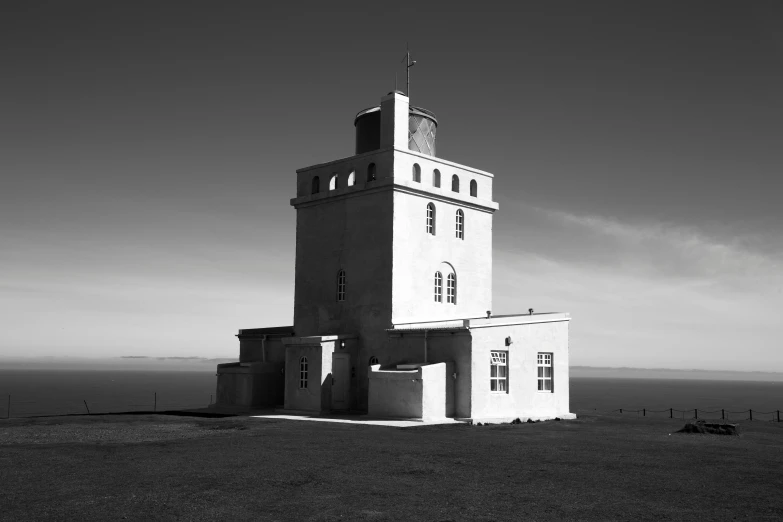 a tall white tower with a large roof