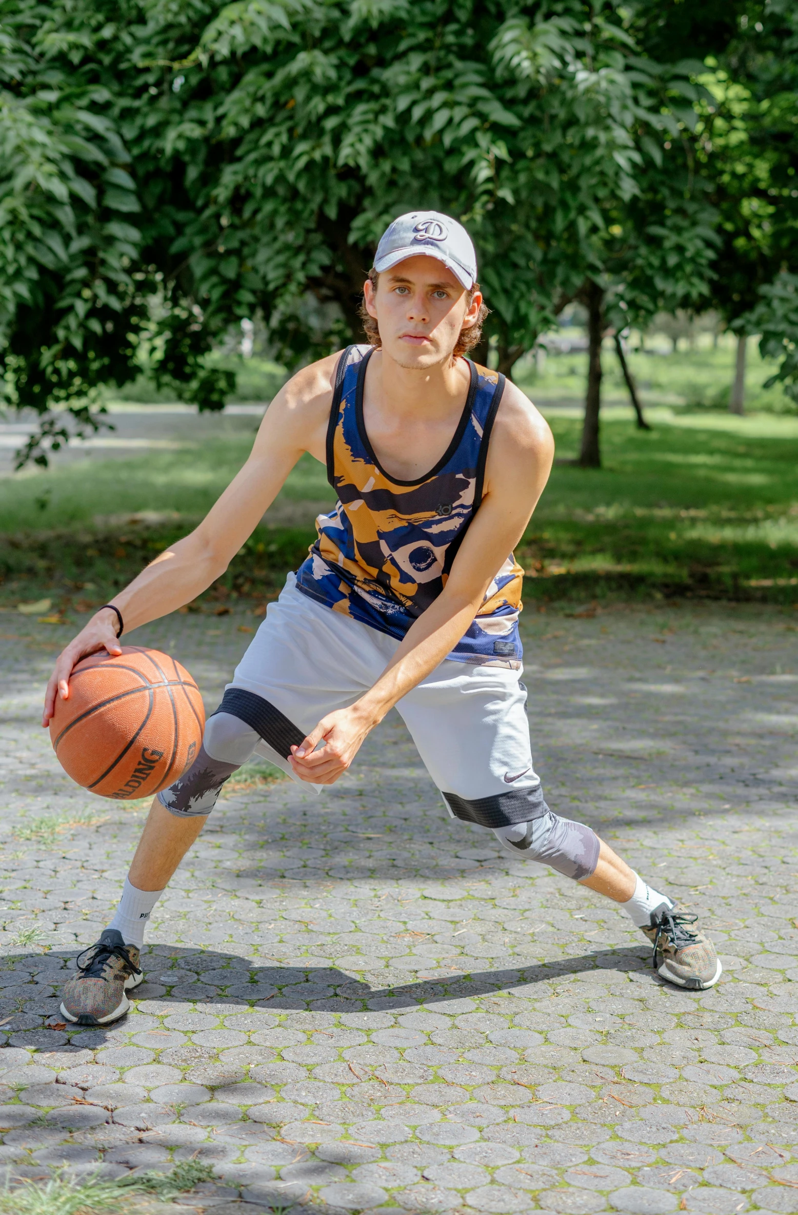 a man standing on one leg and holding a basketball