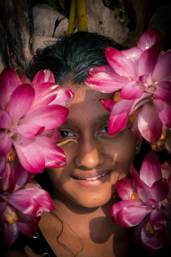 a girl with flowers around her face and body