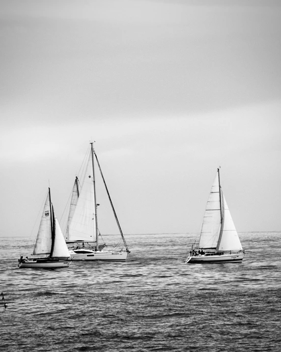 a couple of small boats floating on top of the ocean