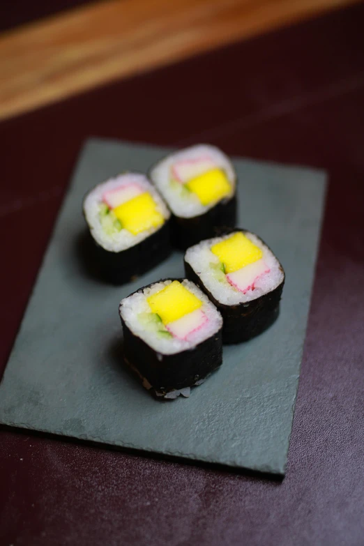 small sushi with some yellow and white toppings