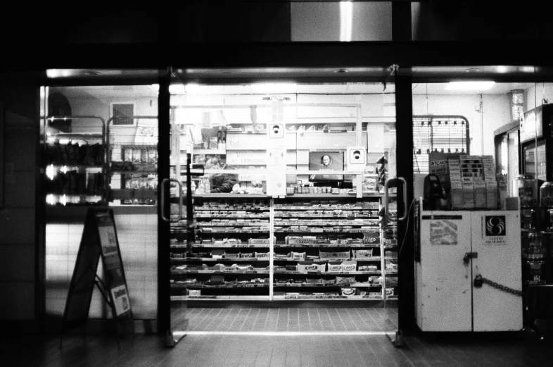 an empty room with a freezer, freezers and shelves in it