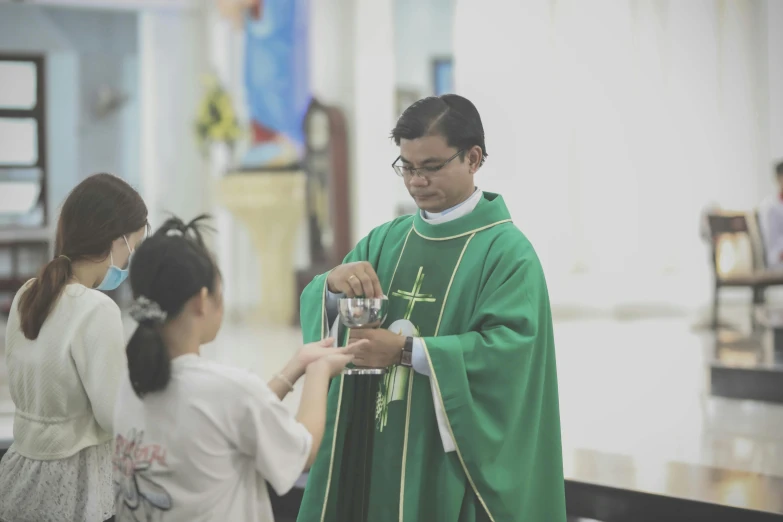 the woman holds her hands out to the priest