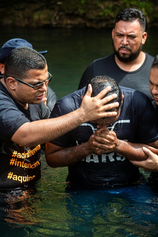 some people stand in the water and hold soing up