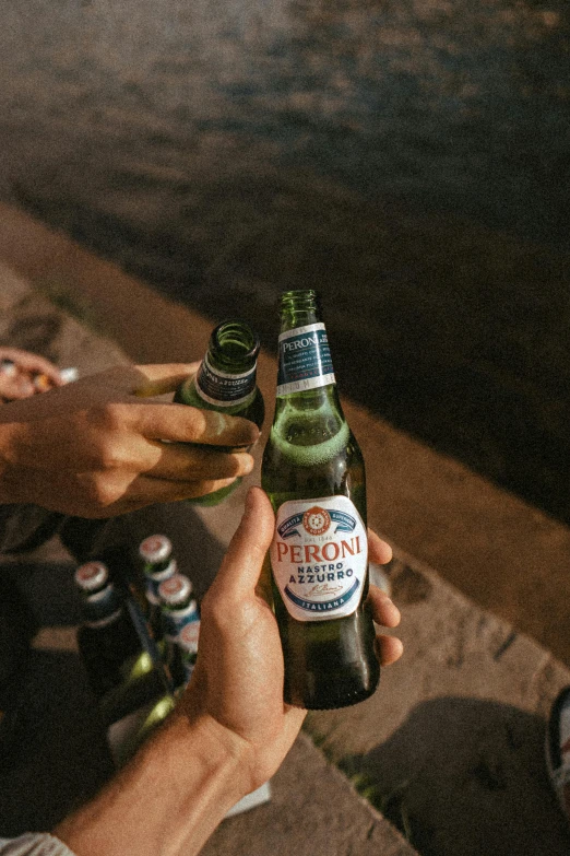 two beers in their hands, being handed one another