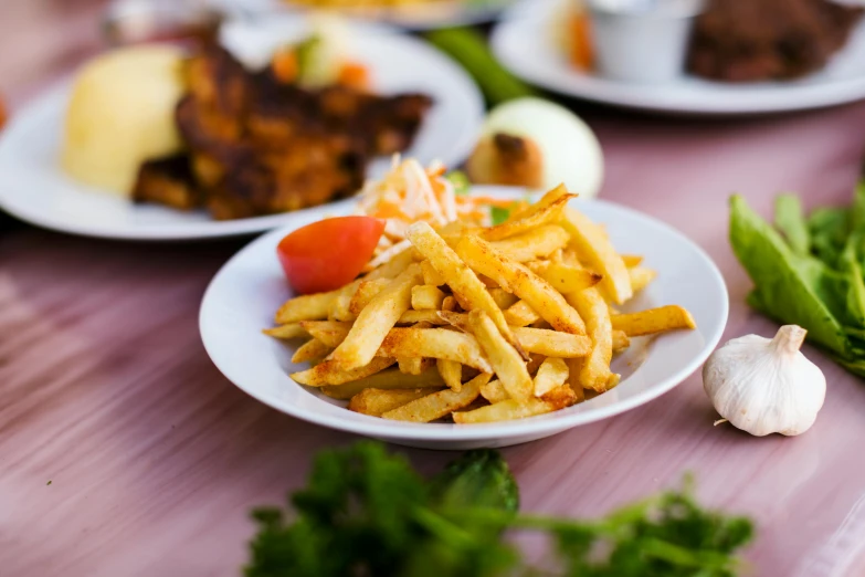 three plates of food with various vegetables next to them