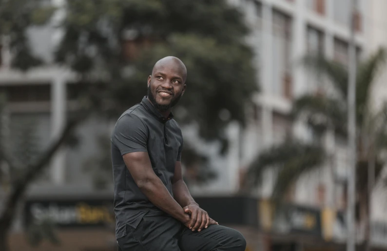 black man with his foot on the ground posing for a picture