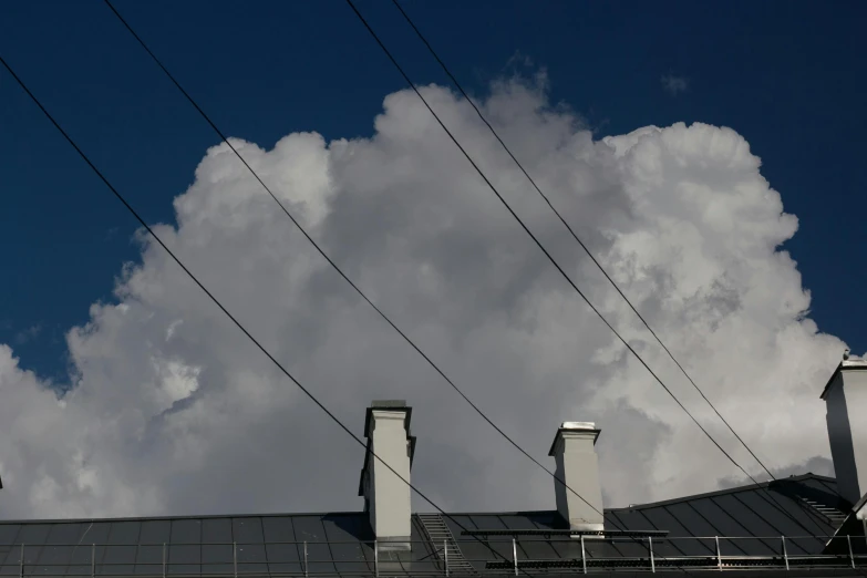 four chimneys with clouds in the background and one blue sky