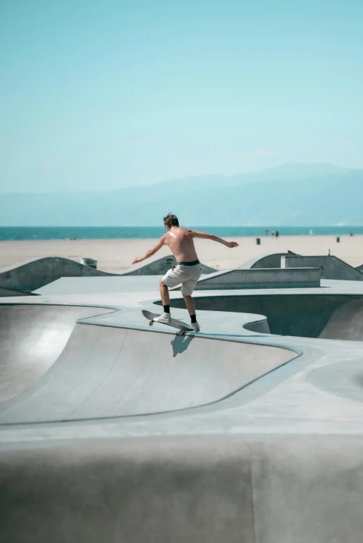 a man riding on a skateboard up the side of a ramp