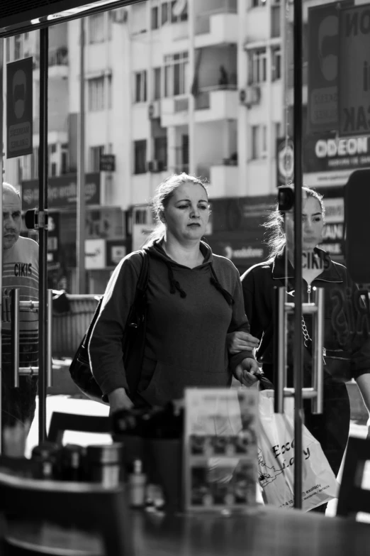 black and white po of a woman at a convenience store