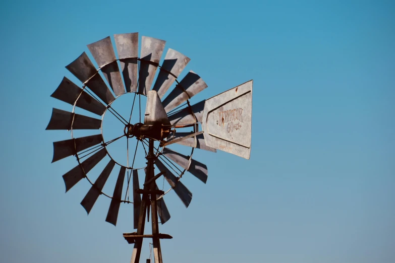 an old wooden windmill with a metal roof