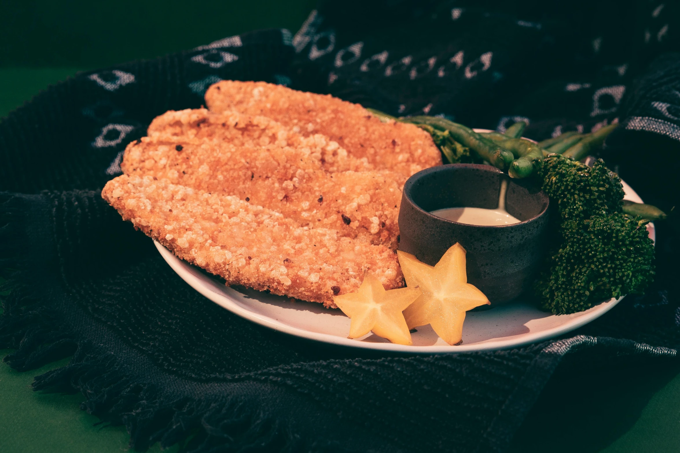 a plate with fried food and sauce on it