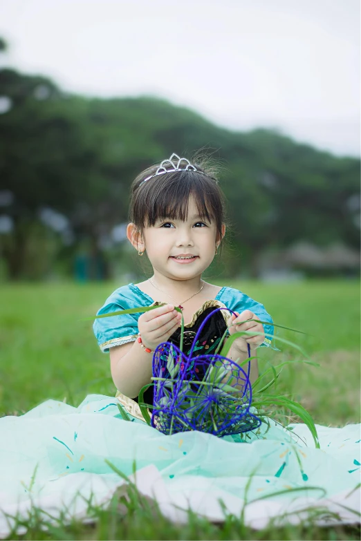 a  wearing a tiara poses for a po on grass