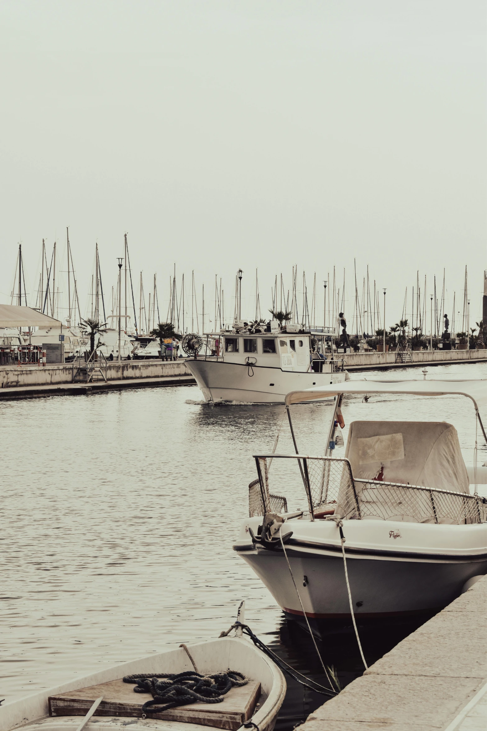 two boats sit at a harbor on the water