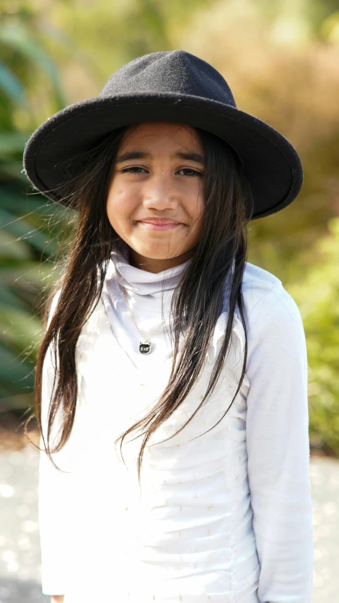 a young child is wearing a hat while posing for a po