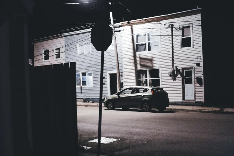 a dark image of cars parked on the side of the road