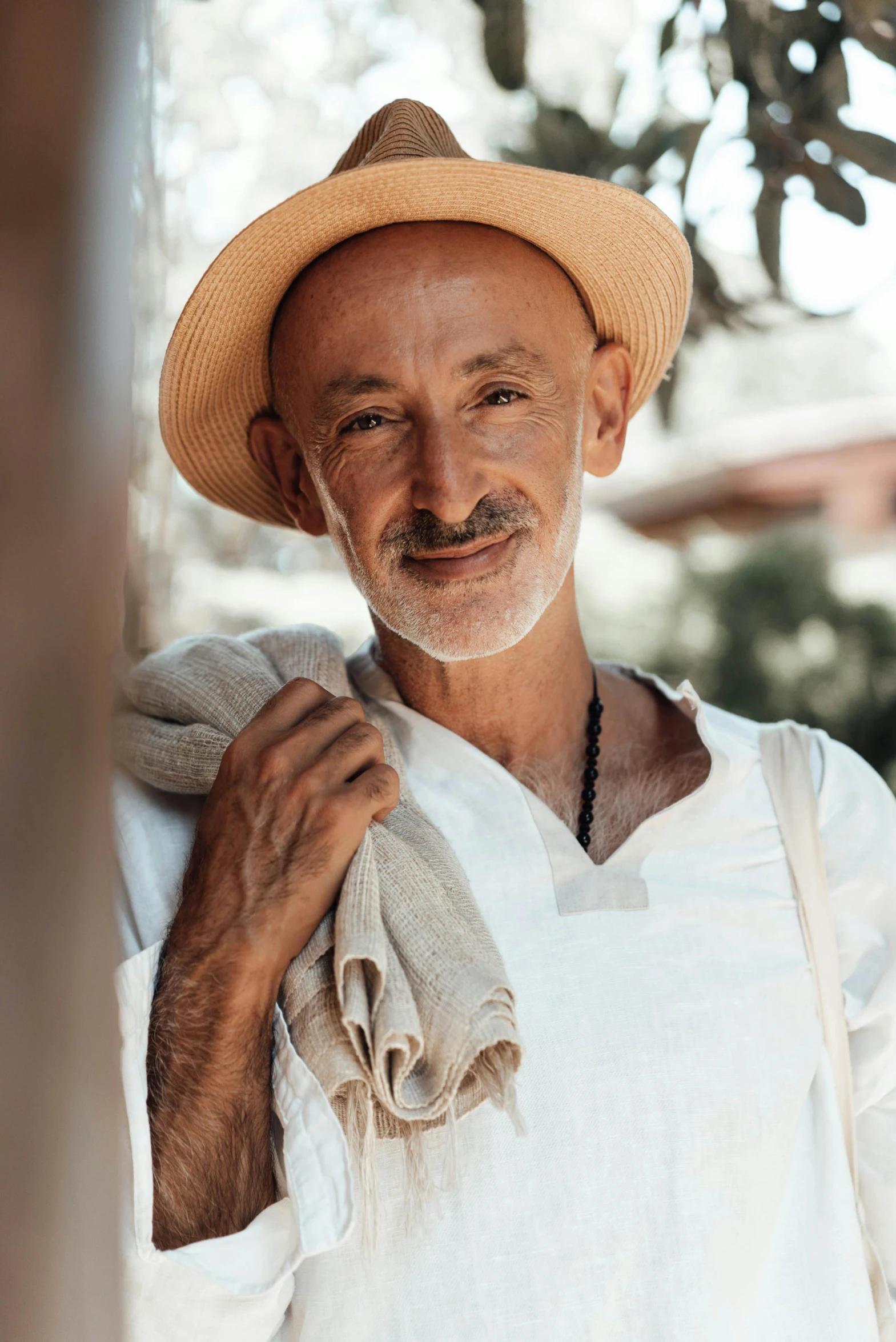 a man is wearing a hat, white shirt and black tie