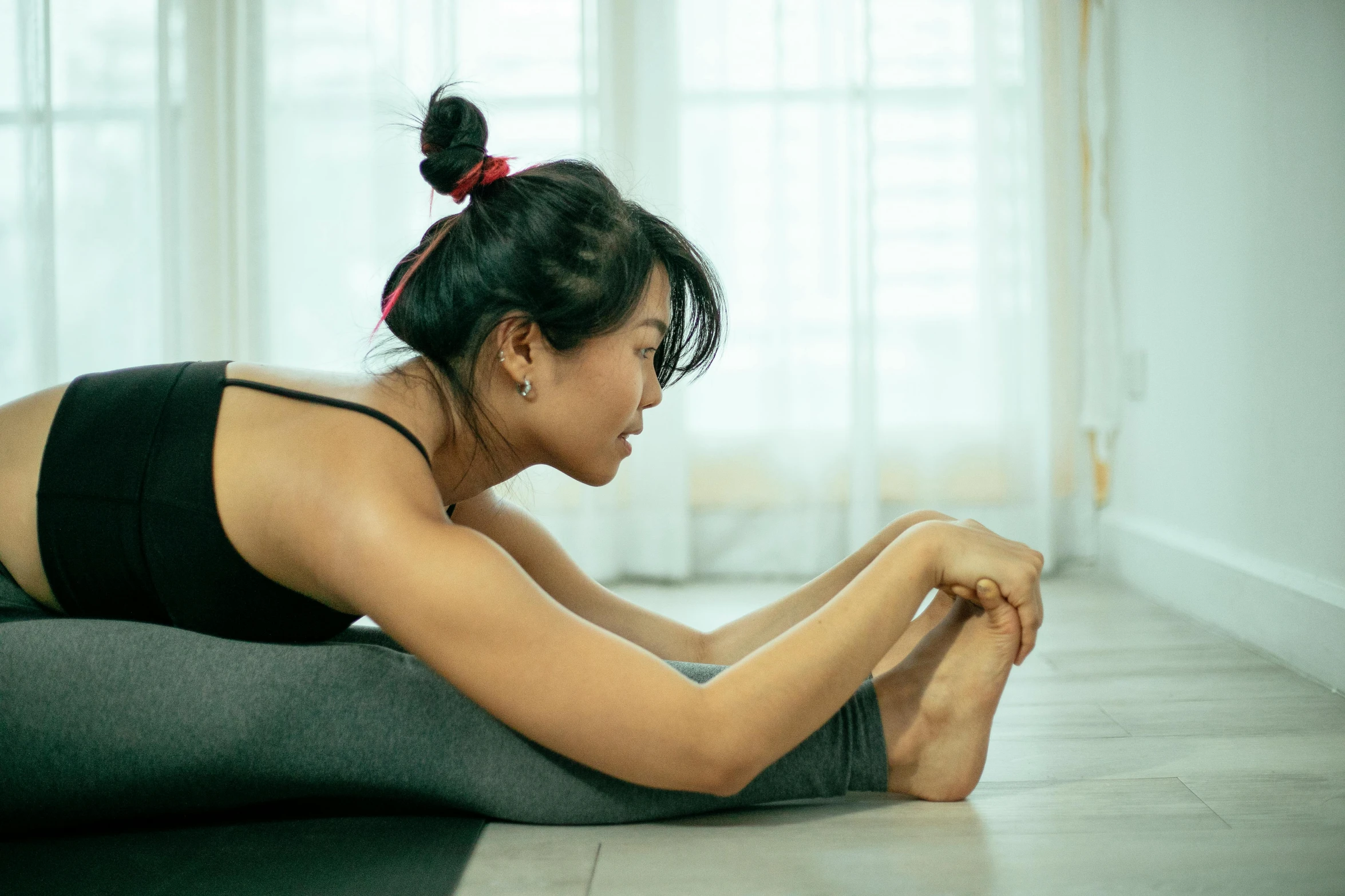 woman on the floor doing an upward stretch