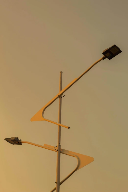 an intersection with multiple streetlights and two traffic lights on each pole