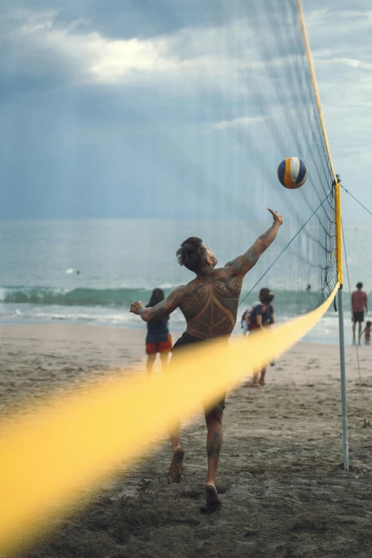 a man is hitting the ball during a volleyball match