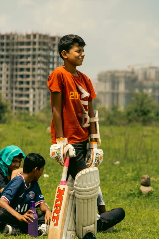 two boys with crutches standing near the stump of a cricket bat