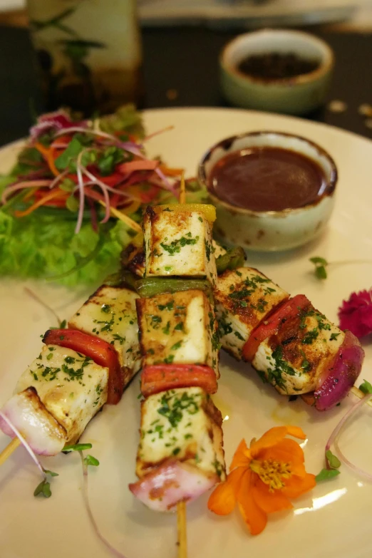 an appetizer set out on a plate with dipping sauce