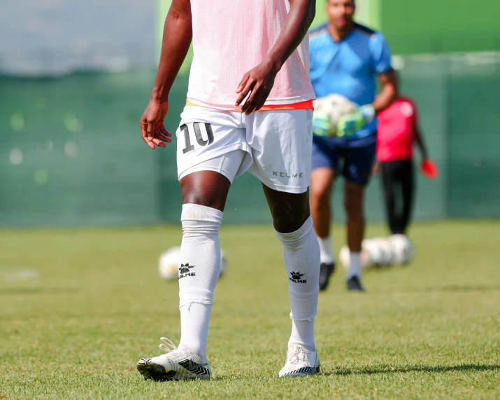 a player in the team wearing pink waiting for the ball