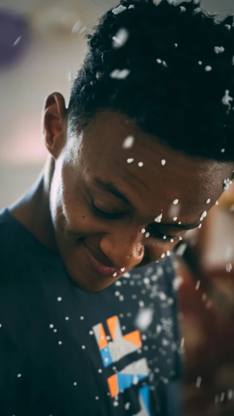 a man blowing snow into his face