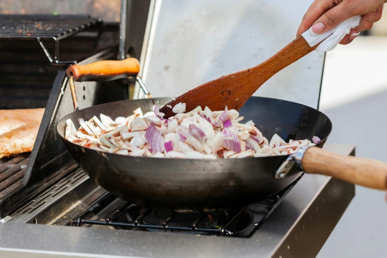 a set on an oven with onions being added