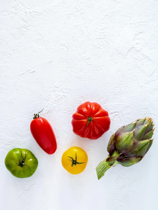 several fruits and vegetables are on a white surface