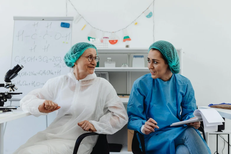 two medical workers are sitting at a table