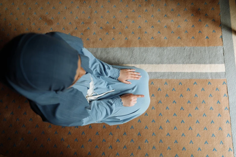 a little girl sitting in the middle of the floor