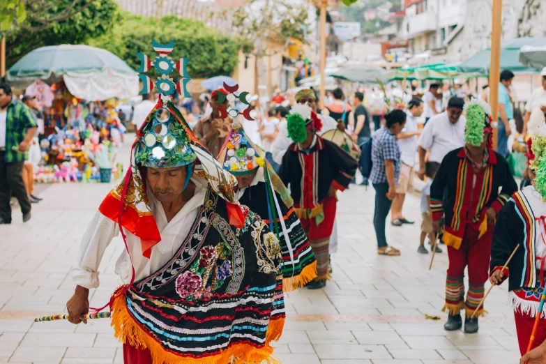 some people wearing weird colored costumes on a crowded street