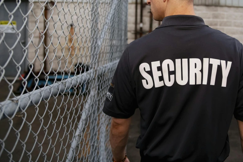 security man walking toward an animal in the cage