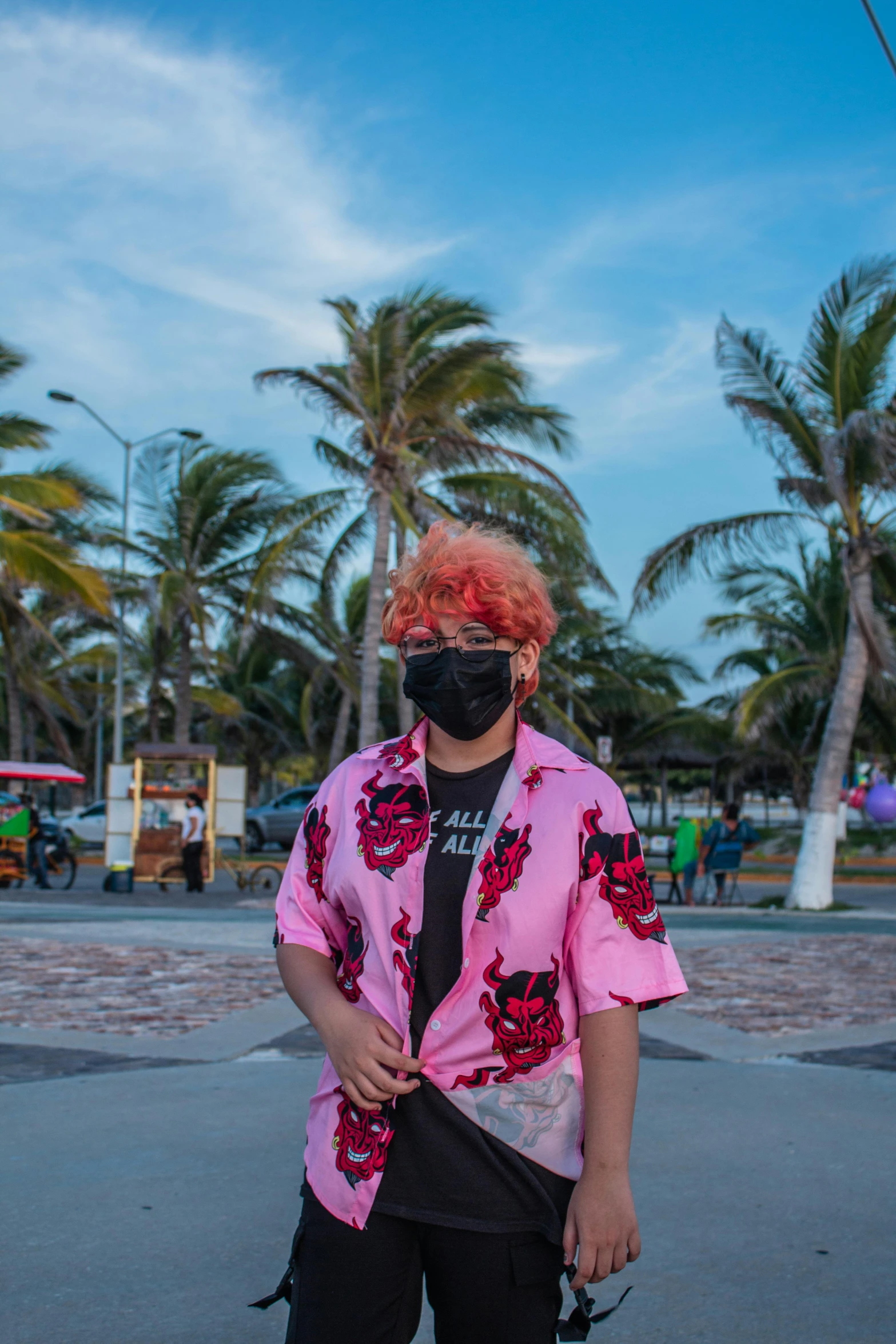 man standing on skateboard wearing a bandanna and a t - shirt