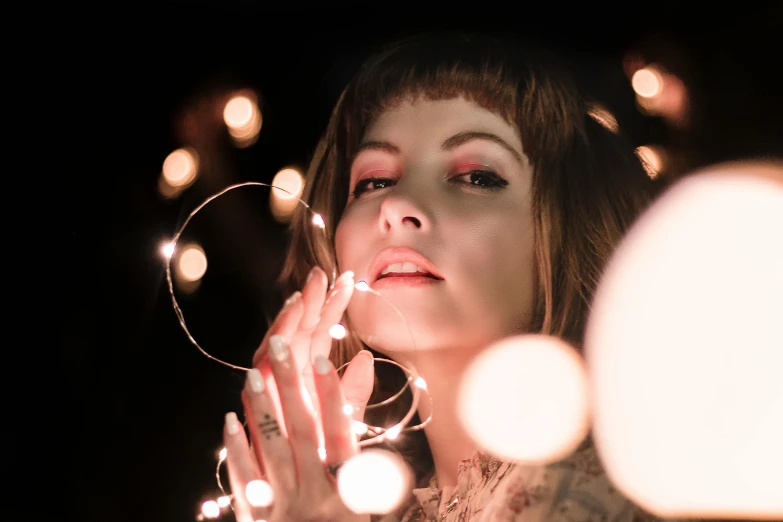 an image of a woman holding some lights