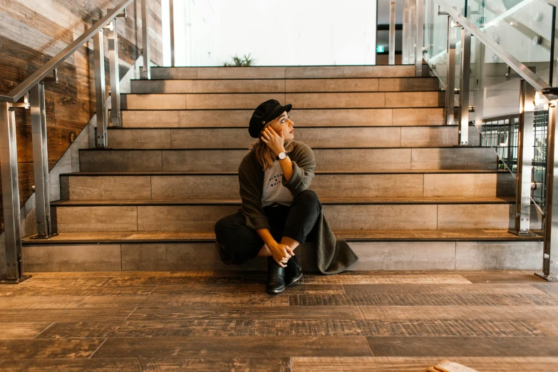 the man is sitting on the steps using his cellphone