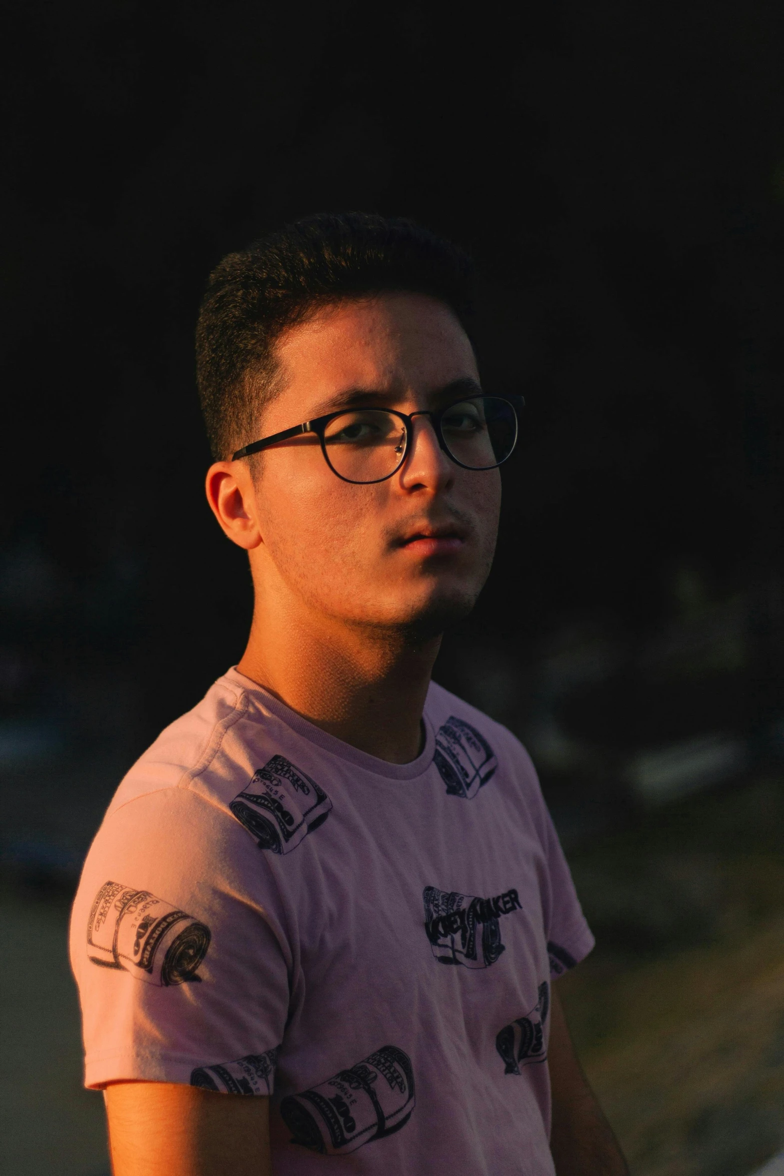 a man in glasses and pink shirt standing