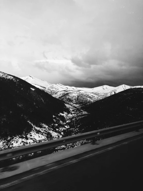 the hills are covered with snow as seen from the highway