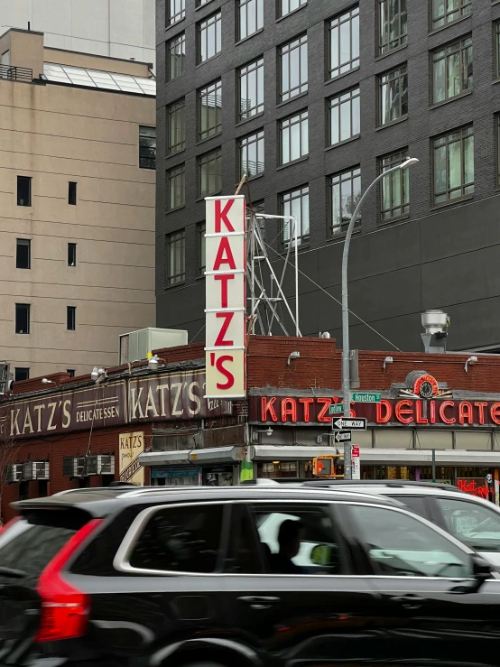 a car passes by on a busy street corner