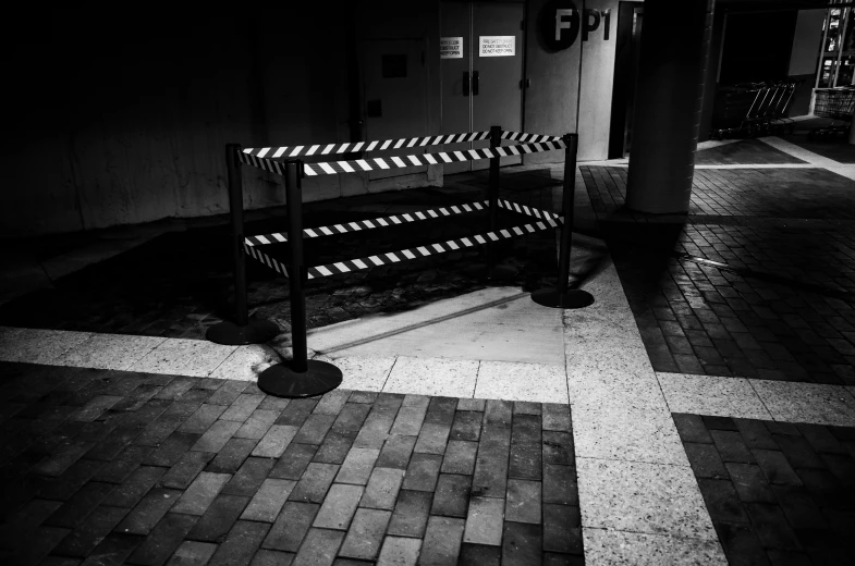 a empty bench at the end of a sidewalk