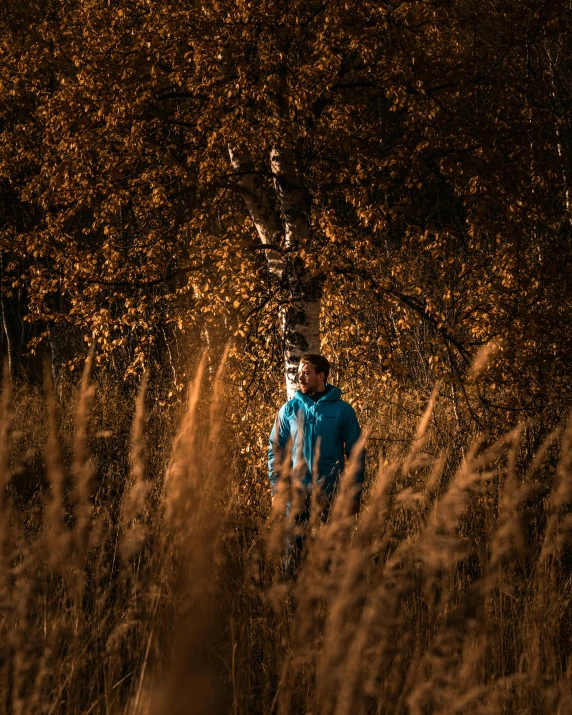 a man is looking down at his reflection in the distance